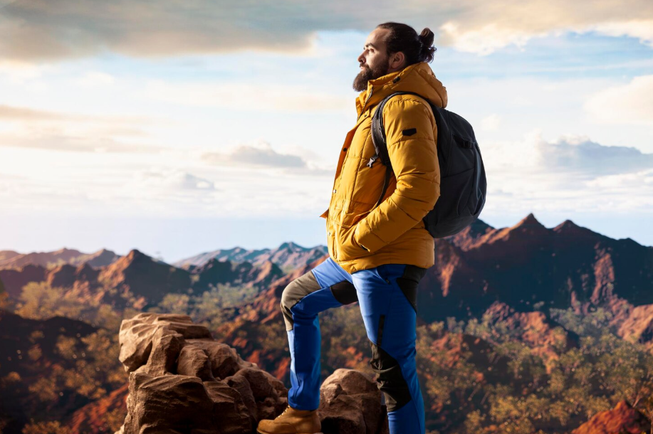 Backpacker enjoying panoramic mountain views, symbolizing self-directed adventure