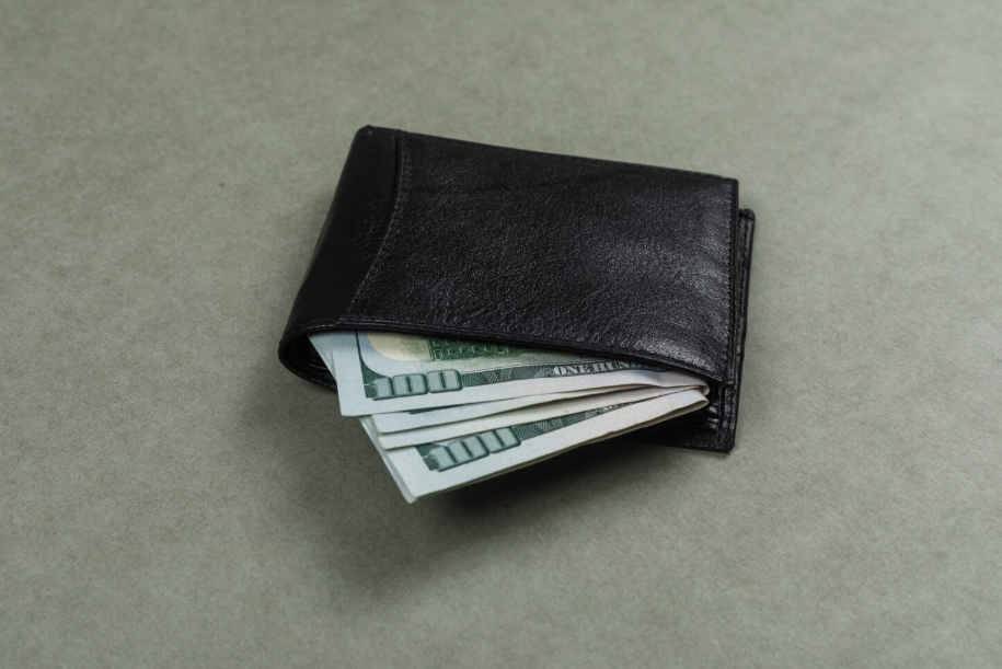 Slim black wallet with cash, a visual for a minimalist wallet setup