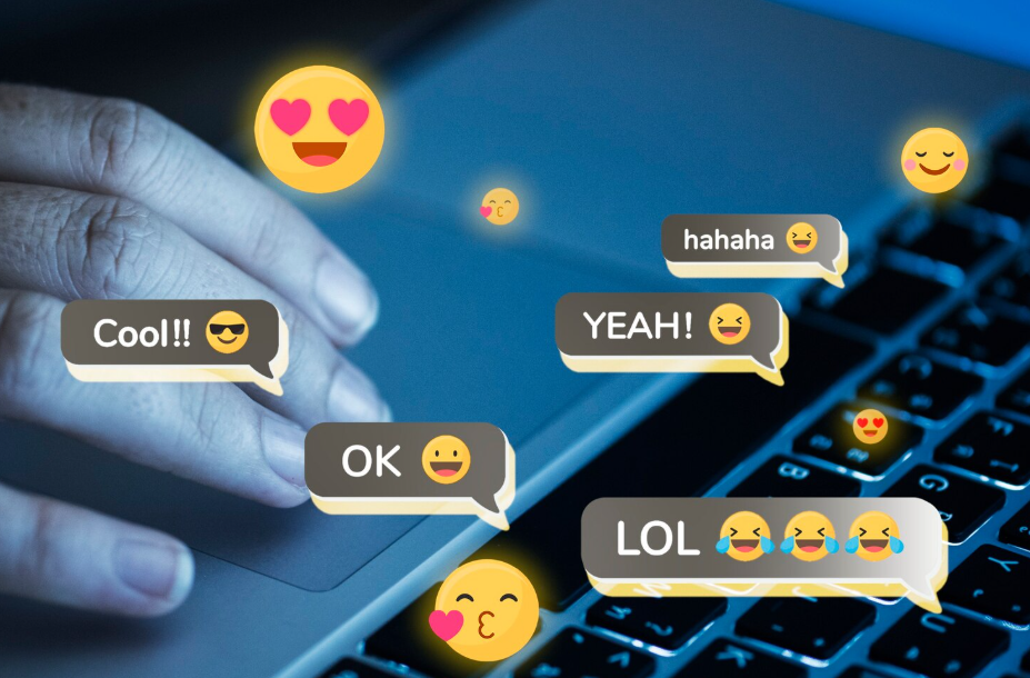 Laptop keyboard with floating emojis and comment bubbles in social media