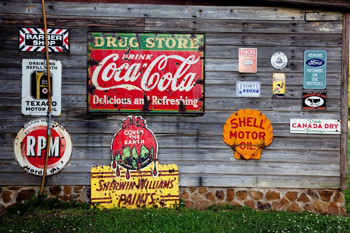 Vintage Coca-Cola, Shell, and Texaco signs, featuring nostalgia marketing psychology in action