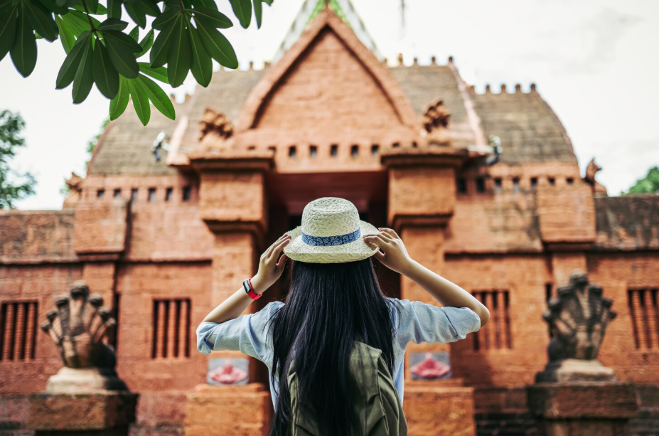 Back view of tourist at a sacred site, showing modest dress and mindful behavior abroad