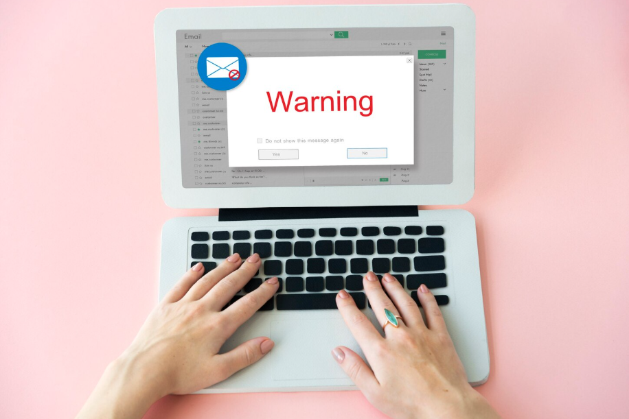 Phishing email warning pops up on laptop screen